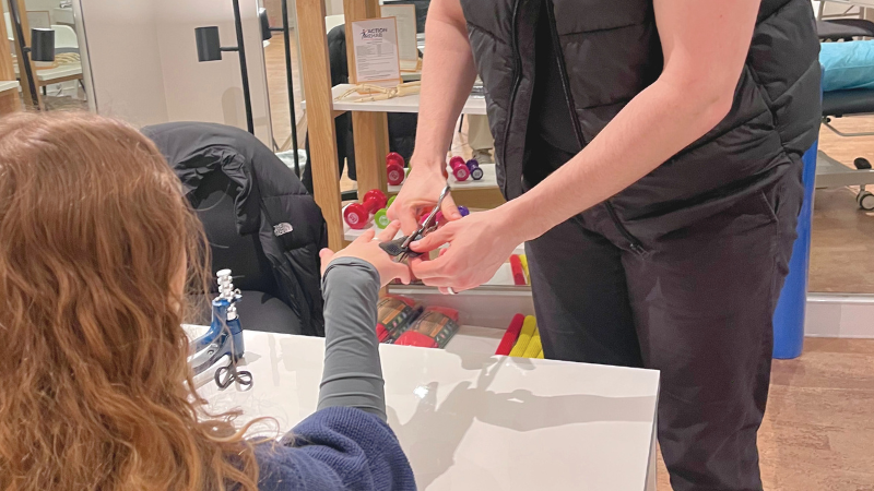 Therapist fitting a thermoplastic splint to a patient’s finger during a hand therapy session with Action Rehab